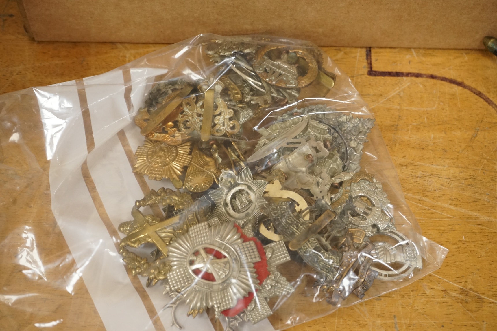 A collection of thirty-six military cap badges, including; the Queen‘s Own Cameron Highlanders, the King’s Own Scottish Borderers, the Argyle and Sutherland Highlanders, the Gordon Highlanders, etc. together with three p